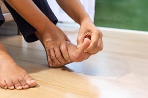 Person performing a foot strengthening exercise to improve stability and balance.